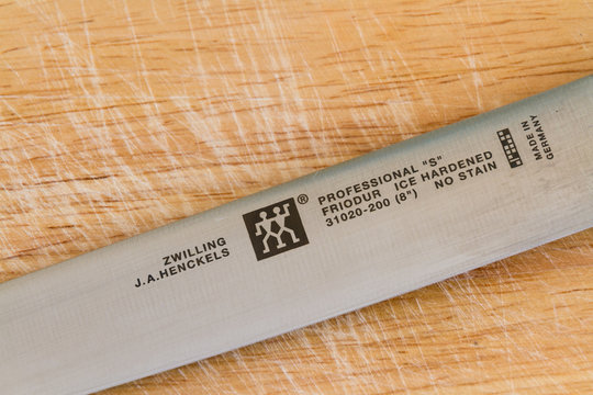 Illustrative editorial of Zwilling J.A. Henckels kitchen knife with logo on wooden chopping board