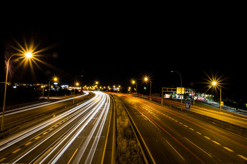 Fototapeta na wymiar vehicle blast on the road at night in long exposure photography