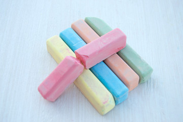 Colorful chalk scattered on a white background.