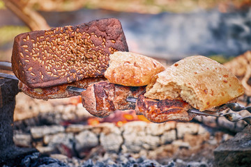 Cooking juicy meat on the grill in the afternoon.