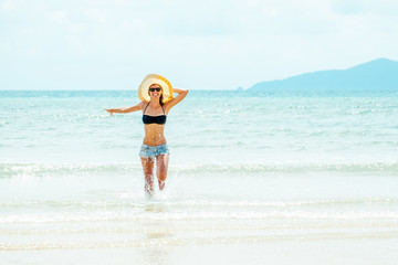 Happy carefree woman wearing bikini having fun on summer vacation
