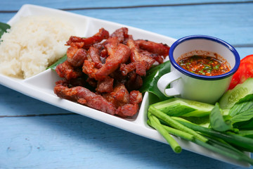 Deep fried sun dried pork and salad served with chilli sauce