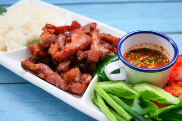 Deep fried sun dried pork and salad served with chilli sauce