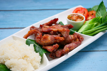 Deep fried sun dried pork and salad served with chilli sauce