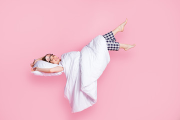 Full length photo of pretty lady enjoy nap lying bed pillow blanket sleep walk raise legs up empty...