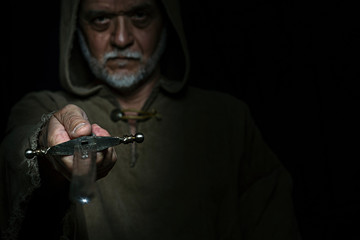 Medieval monk as a fighter with a dagger