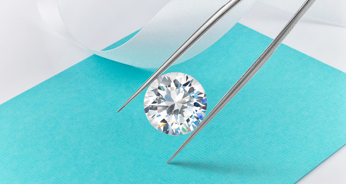 Loose Diamond on Background Held in Tweezers 