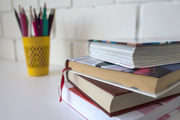 Study. Back to school. School supplies on a white background. Pencils, books, a globe.