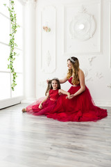 mother and daughter in same outfits posing in studio