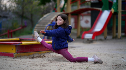 Portrait of a pretty little girl with long loose hair on playground