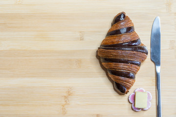 Croissant for breakfast on wooden background
