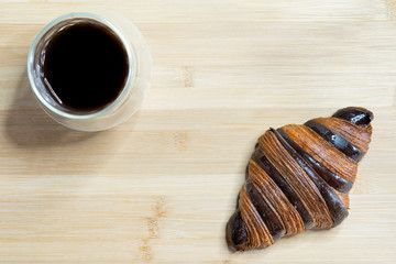 Cup of black coffee espresso and croissant