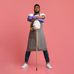 Professional African American Cleaner Posing With Mop Over Pink Background