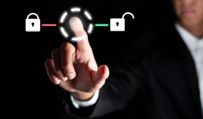 businessman touch on graphic for icon with fingerprint to unlock the key in office to scan for...