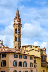 Fototapeta na wymiar The tower of the Badia Fiorentina in Florence, Italy. Abbey and church, home to the Monastic Communities of Jerusalem situated on the Via del Proconsolo in the centre of the city. Vertical photo.