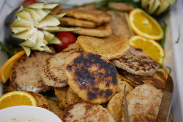 Fish burgers with lemon and tomato, food at a high category hotel, all inclusive menu