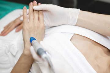 Hands concentrated picture. Beautician hold client's palms and doing rejuvenation treatment. Care about hands skin.