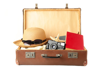 Vintage suitcase and beach accessories isolated on white background