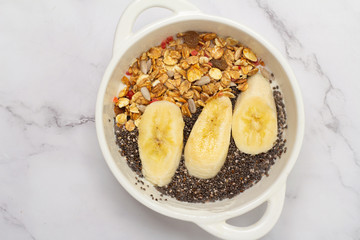 smoothie bowl with chia, banana and granola close up
