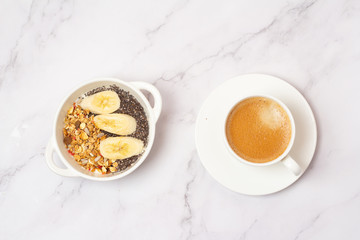 smoothie bowl with chia, banana and granola and coffee
