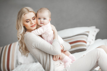 Young mother with little baby. Mommy holding her cute child. Maternity concept.