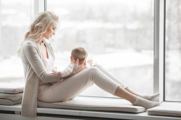 Young mother with little baby. Mommy holding her cute child. Maternity concept.