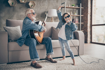 Photo of two people grandpa play guitar little granddaughter mic singing rejoicing cool style...