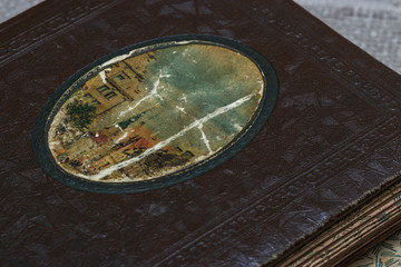 Old photo album with dilapidated pages and a clan cover of the 18-19th century. Houseware. Storing photos and preserving memory.