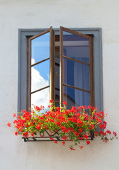 Fototapeta na wymiar Window with flowers. Cesky Krumlov, Czech republic.