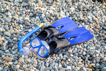 flippers, mask, snorkeling equipment lies on the shore