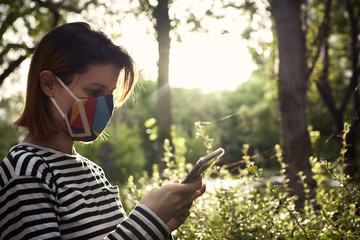 Young woman checking out her mobile phone, first controlled departure from quarantine, phase zero.