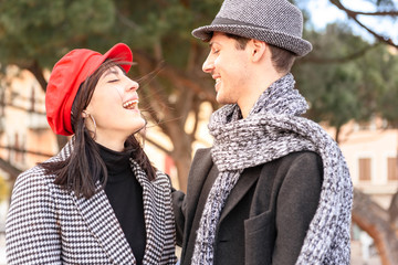 Fototapeta premium Handsome man and pretty woman. Portrait of beautiful couple. Beautiful girl with red hat.