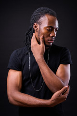 Portrait of young handsome African man with dreadlocks
