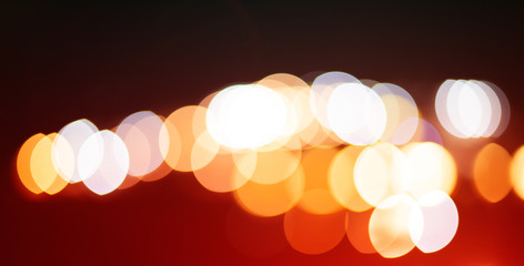Red and orange holiday bokeh. Bokeh photo of LED light. Abstract defocused of red and yellow LED light on black background. Red and yellow bokeh. 