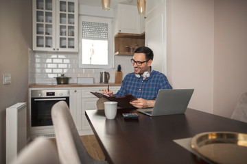 Businessman writing notes in his notebook.