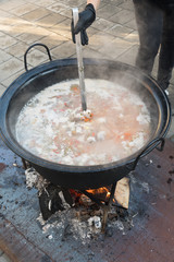 Cooking pot over campfire, stew preparing open grill steaming. Outdoor fireplace camping concept.