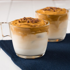 Whipped dalgona coffee on a white wood background - ダルゴナコーヒー