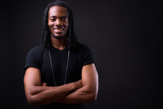 Portrait of young handsome African man with dreadlocks