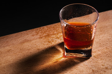 glass from whiskey on wooden table