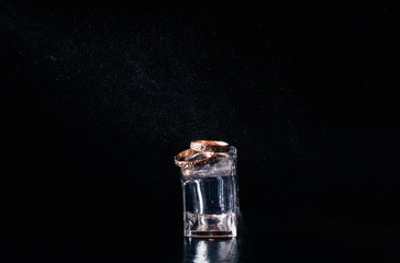 wedding rings on the black background