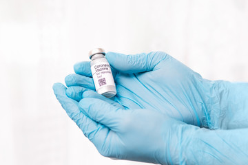 Coronavirus vaccine. Doctor with a vaccine. Hands holding a coronavirus vaccine ampoule, Covid-19