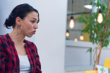 Woman with angry face discussing with her boss inside modern co working space.