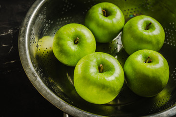 Close-up green apples on the rustic wooden background. Selective focus. Shallow depth of field.