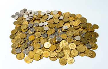 Money. A pile of coins of different denominations lies on a white background. All money is new Israeli shekels.