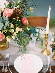 Dining table decorations and festive table setting outdoor closeup. Romantic vacation on the beach