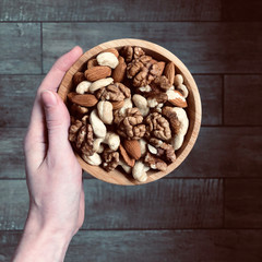 almonds, cashews and walnuts on wooden background