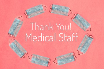 Thank You Medical Staff Phrase with Medical or Surgical Face Masks Isolated on Pink Background