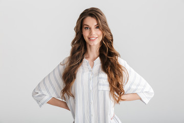 Image of smiling caucasian woman posing with hands on her waist