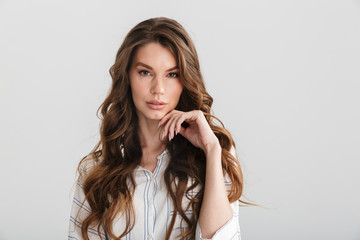 Image of thinking caucasian woman posing and looking at camera