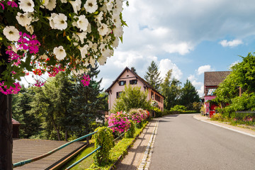 Flowering village in Alsace. Decoration of street lamps with potted flowers and plants.